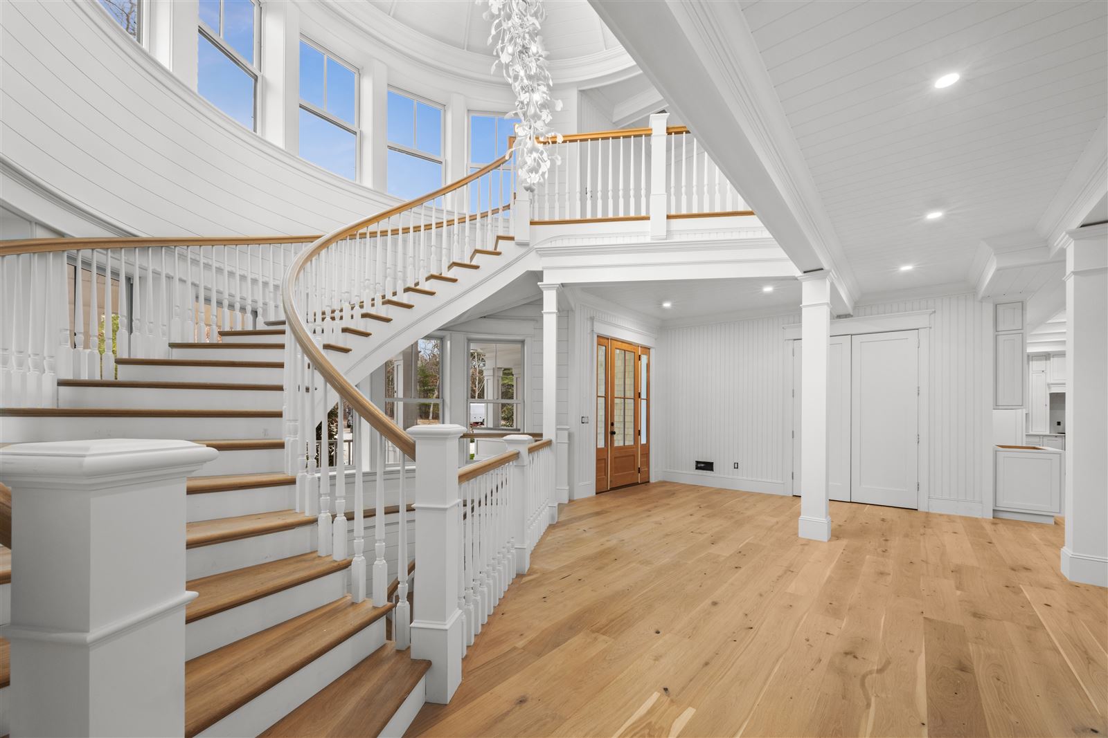 The grand spiral staircase beneath the domed rotunda and cascading chandelier