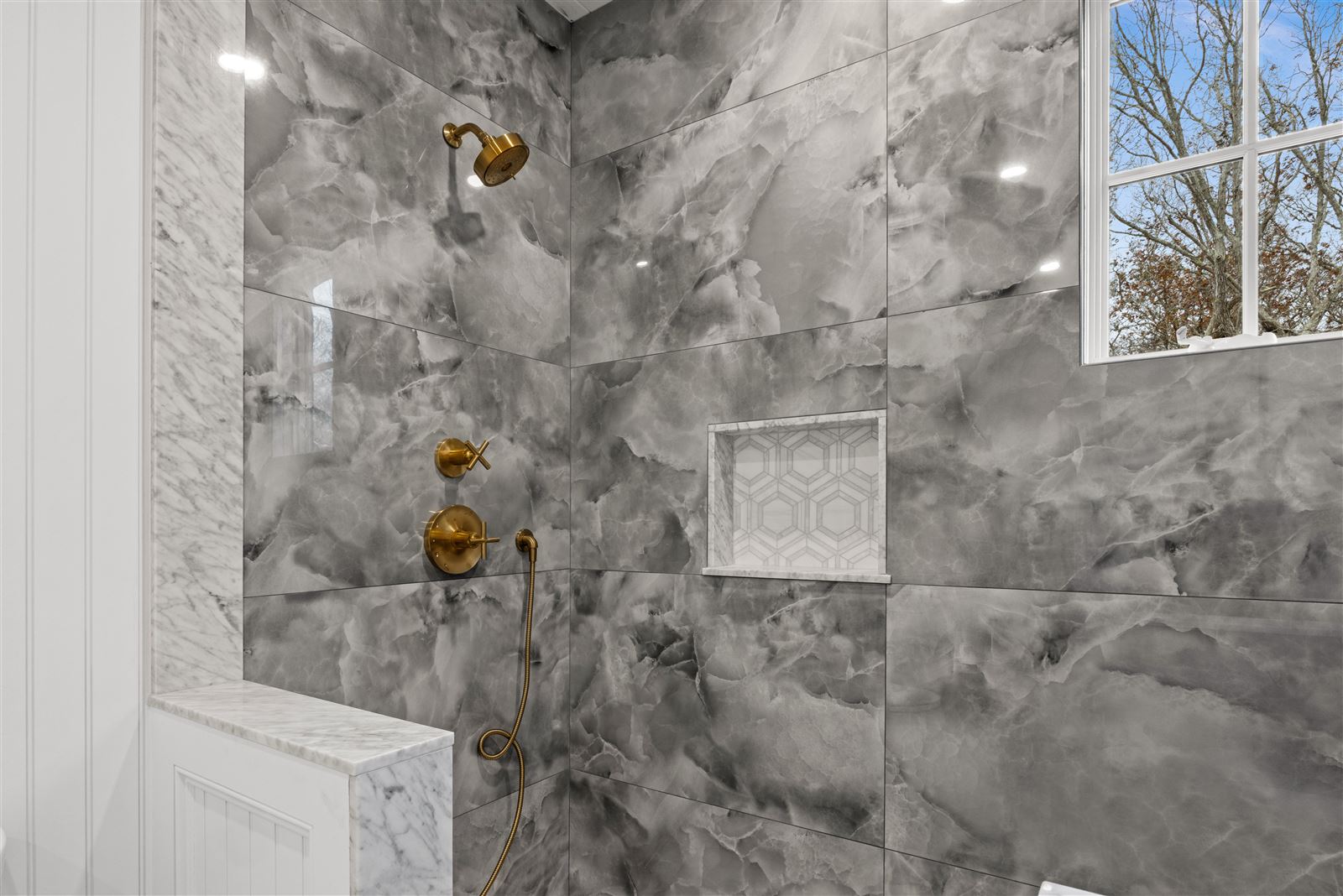 Marble shower, gold fixtures