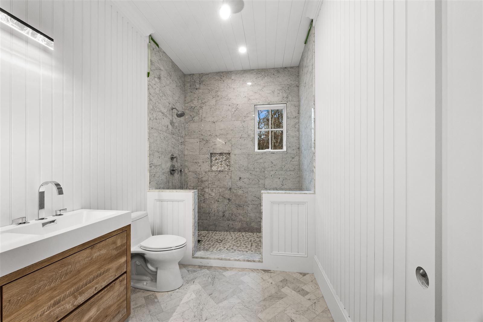 Marble walk-in shower with window