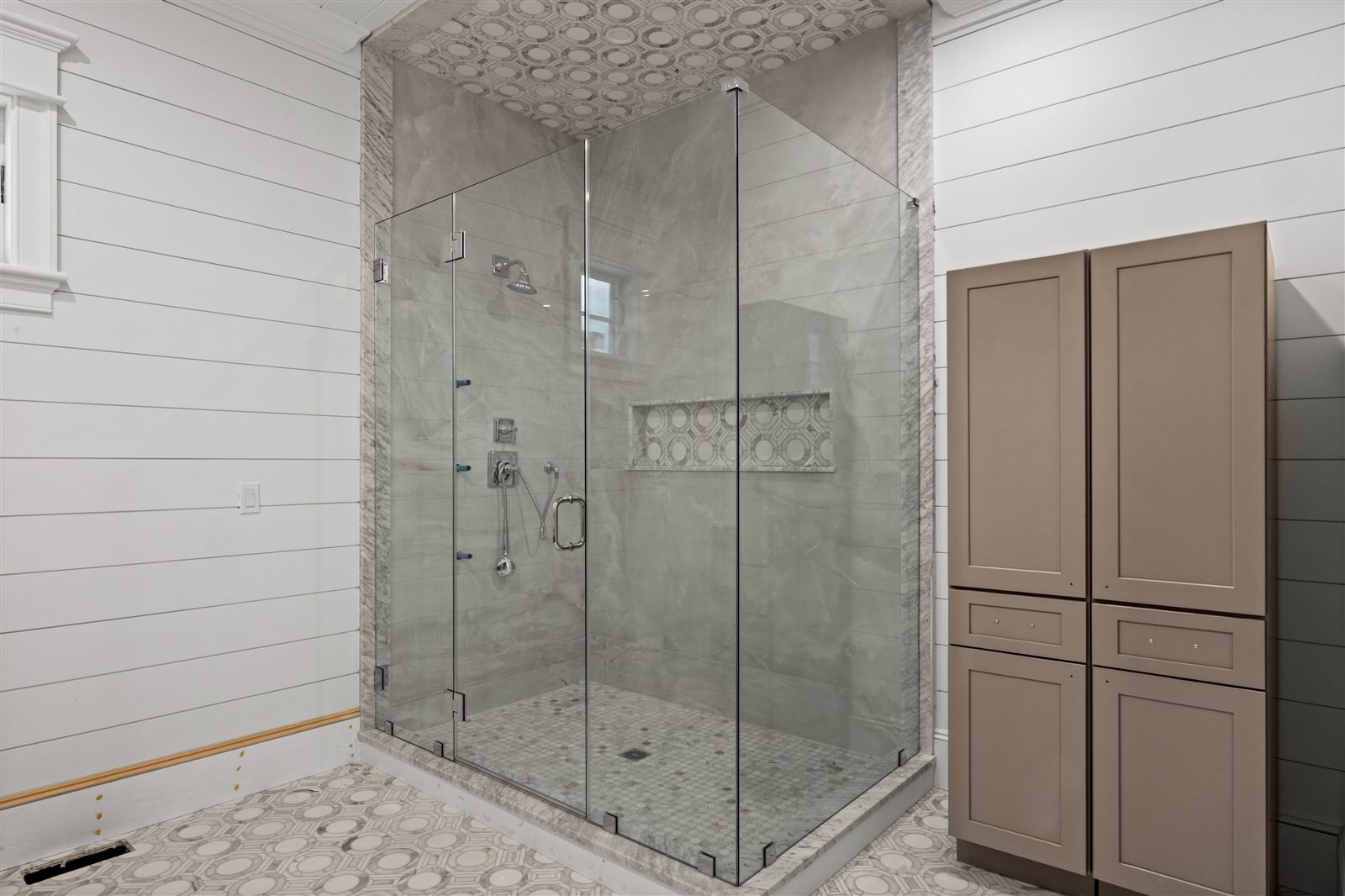 Glass-enclosed marble shower